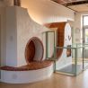 Completed masonry heater finished with terracotta facing tiles and tomette tiles